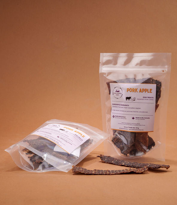 Pouches of dried pork and apples on a brown background