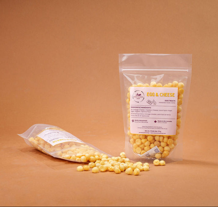 Small yellow dog treats on a brown background
