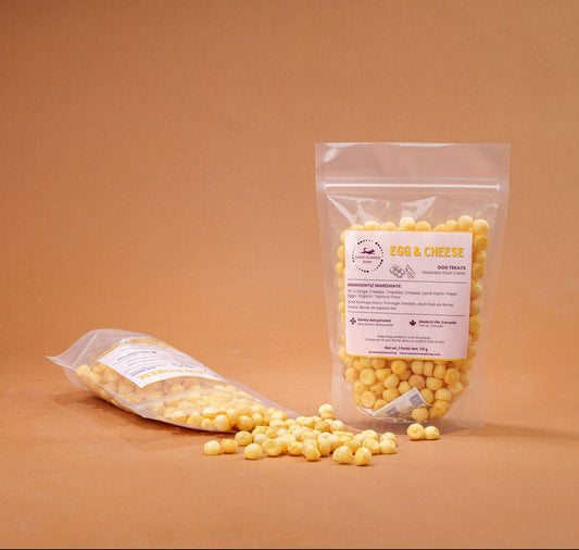 Small yellow dog treats on a brown background